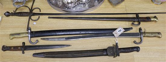 Three late 19th century French bayonets, a US Army bayonet, an EFD 1892 bayonet and an epee